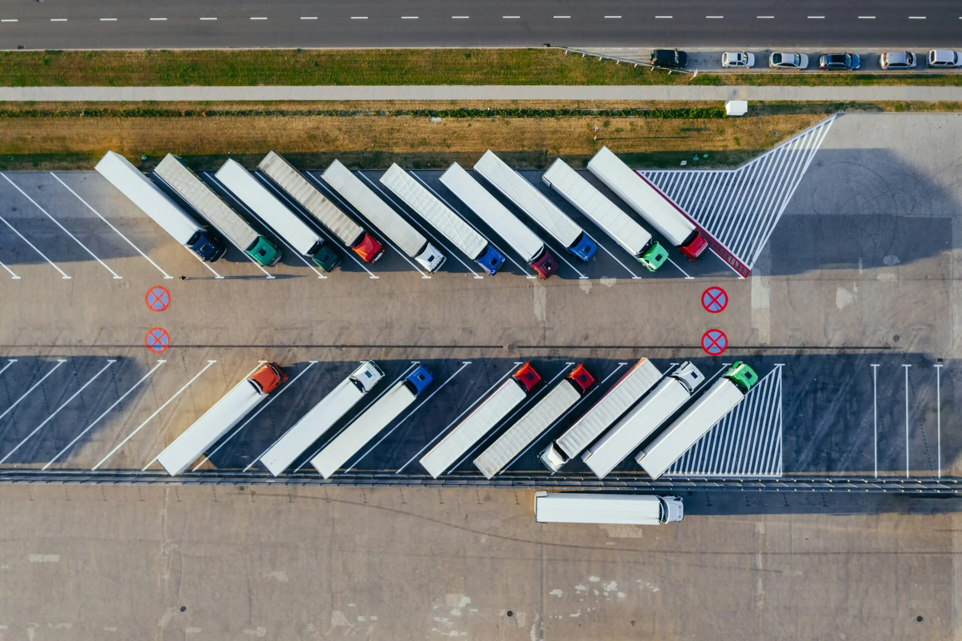 Aerial view of freight trucks parked at a logistics depot
